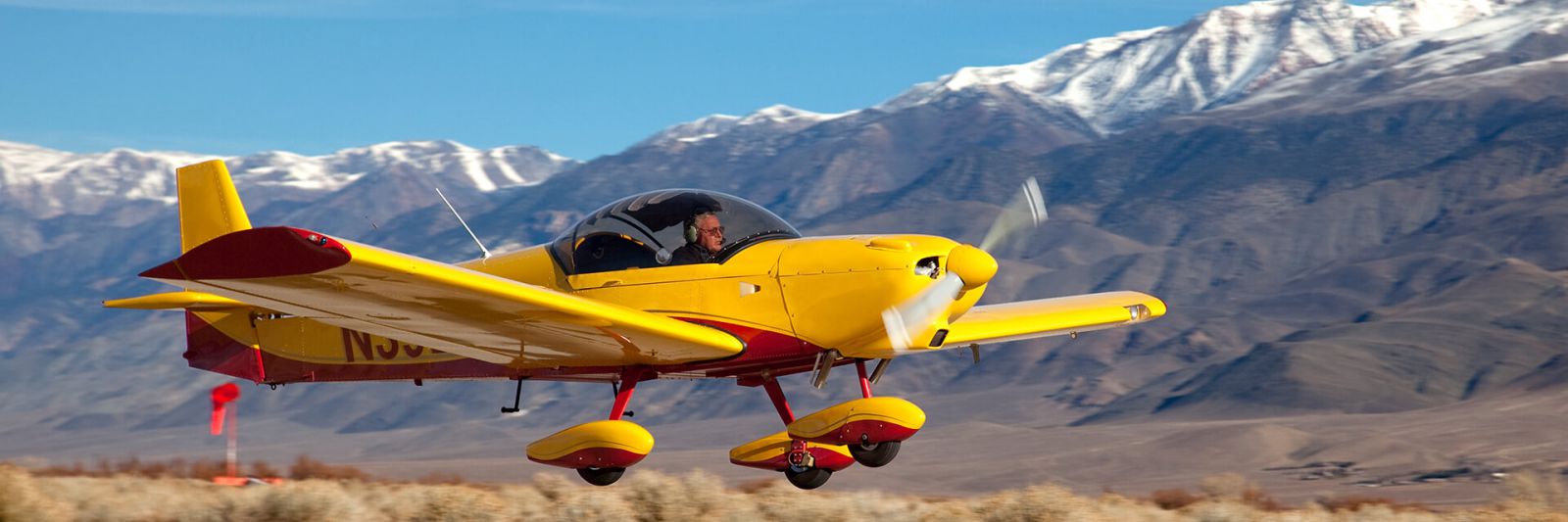 A light sport aircraft landing at a high mountain airport.