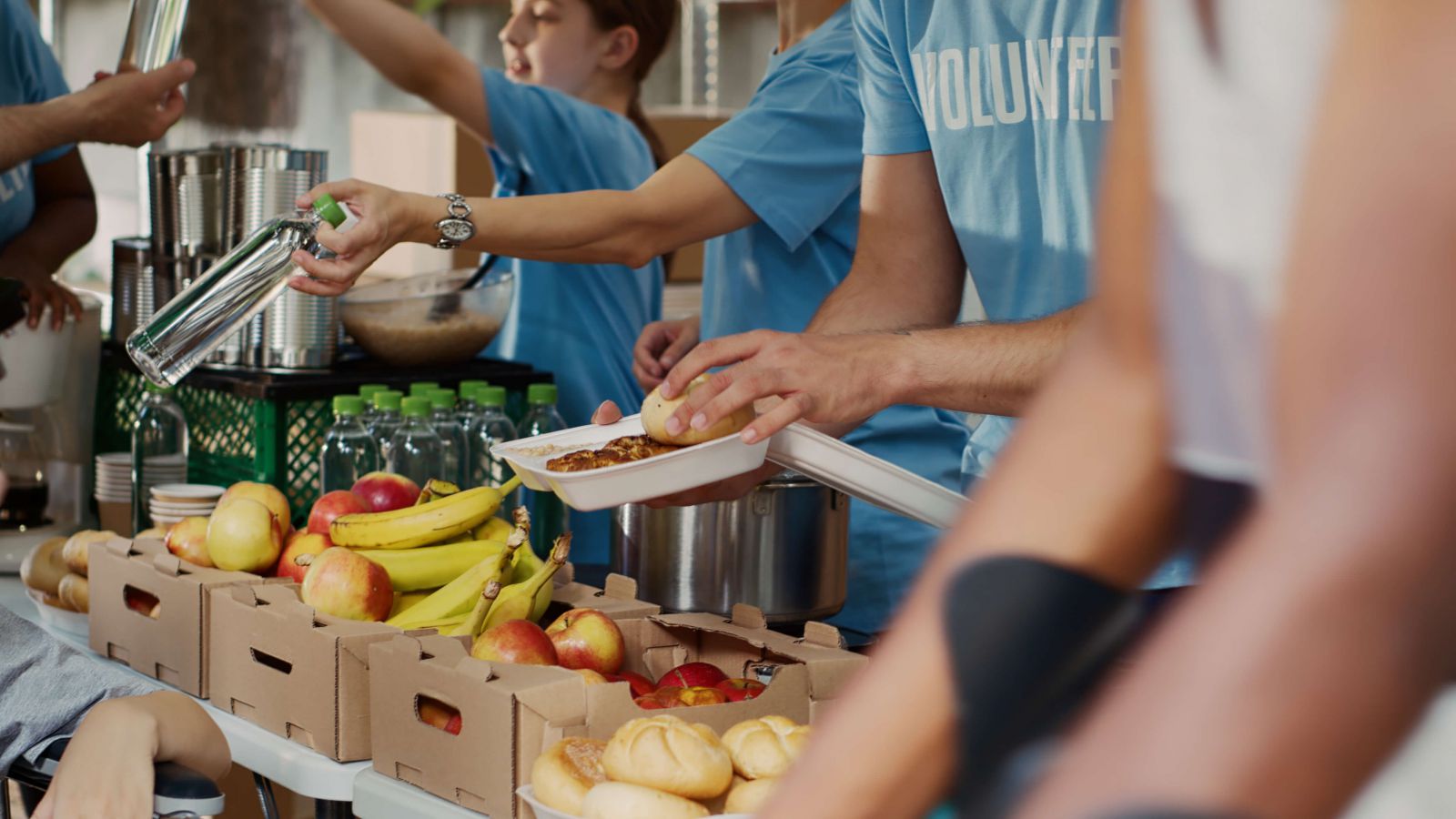 Volunteers serving food at a community event, highlighting Sunoco's support for Aga Khan Foundation USA in combating global poverty.